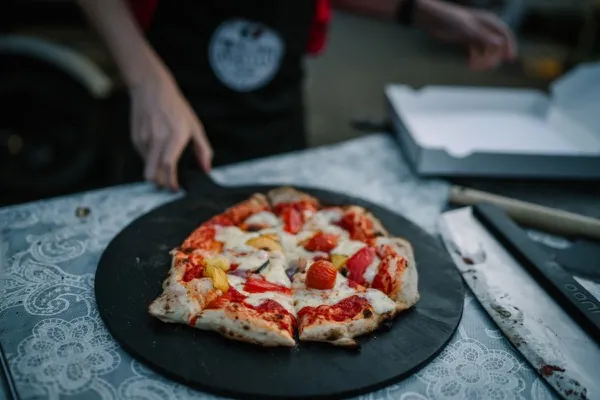 Beautiful pizza topped with fresh vegetables and mozzarella